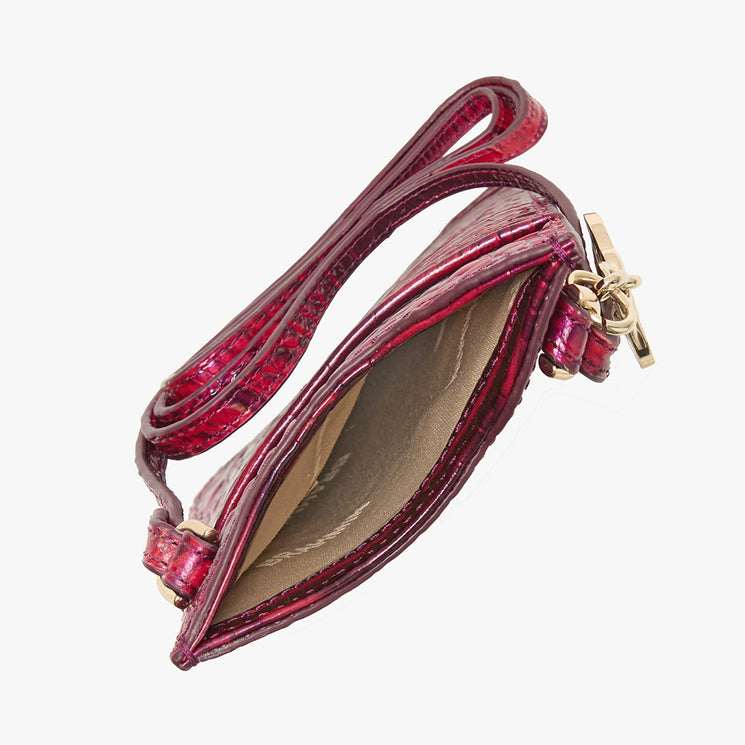 BRAHMIN Eris small wristlet in textured red with a gold zipper, back slide-in pocket, and top zip closure. Shown from above with the interior open and empty against a white background.