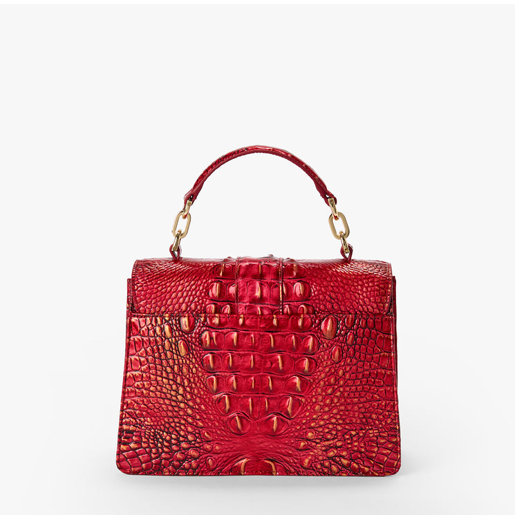 BRAHMIN Small Hallie red satchel with embossed textured pattern, structured silhouette, top handle, flap turn lock, gold-tone hardware, and adjustable crossbody strap on white background.
