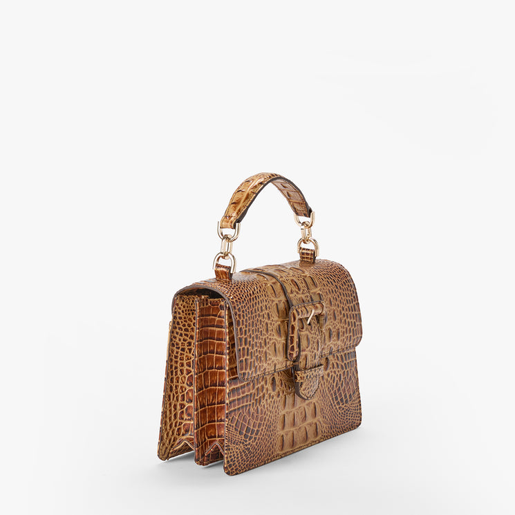 Brahmin brown embossed handbag with a structured rectangular silhouette, top handle, gold-tone hardware, and textured pattern. Shown upright on a white background.