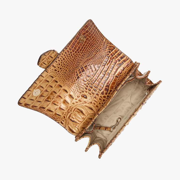 Brahmin brown clutch with embossed texture, snap closure, gold-tone hardware, and structured silhouette. Shown open to reveal beige lining with multiple compartments, key clip, and spacious interior.